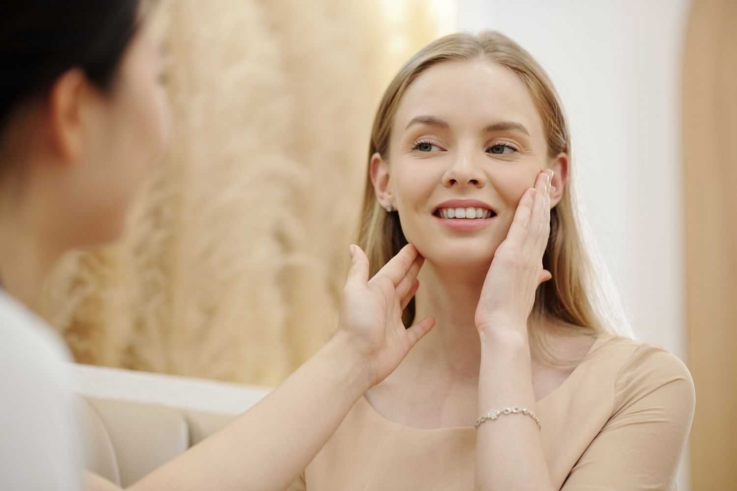 Woman enjoying a skincare consultation at a spa.